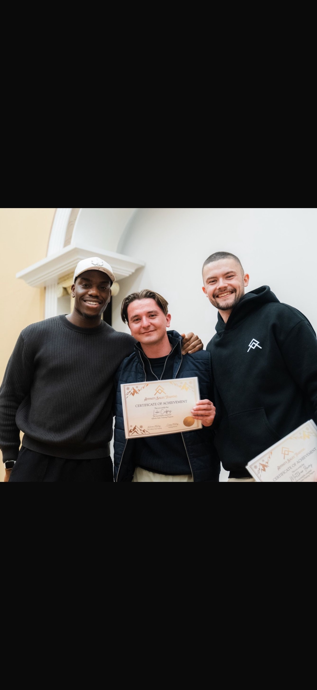 Joshua with team member holding AST certificate