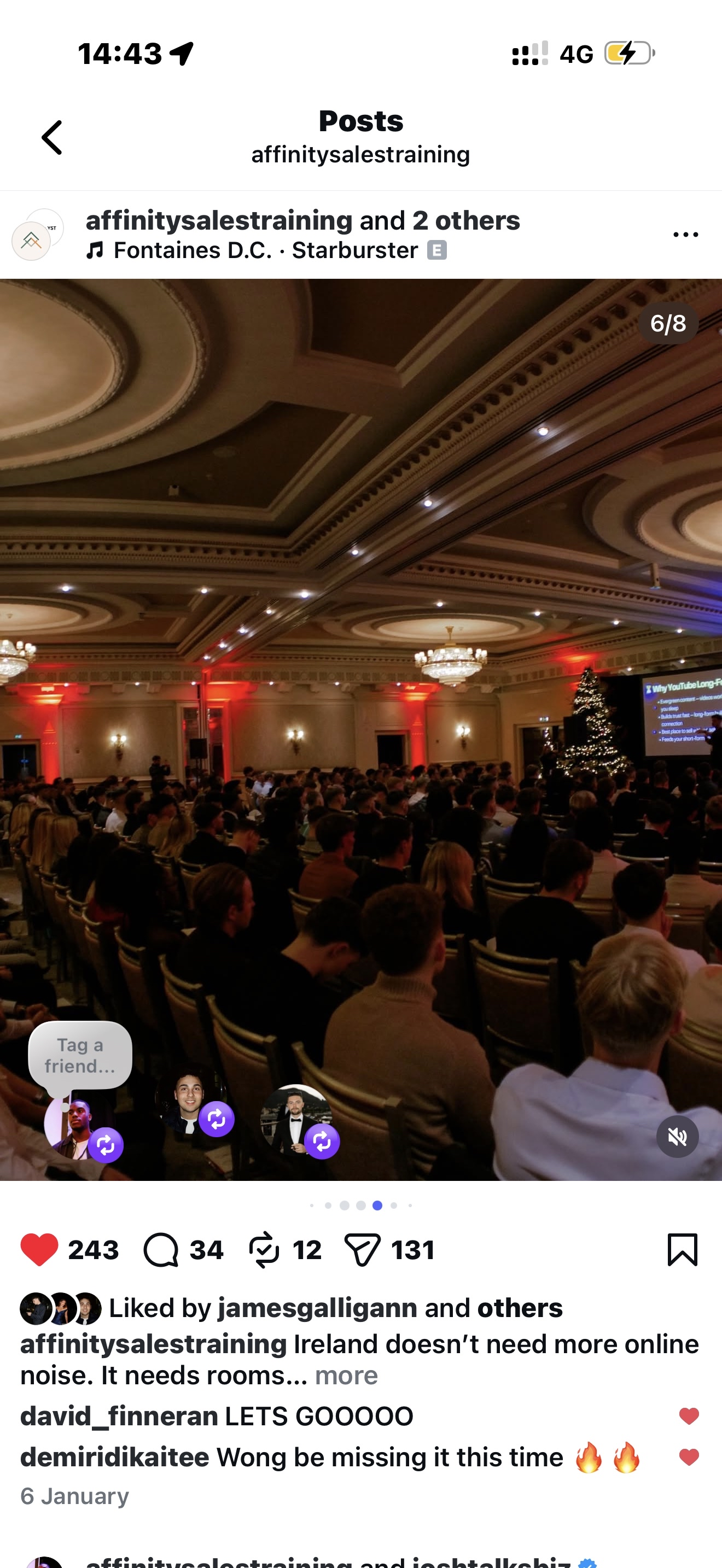 Joshua speaking to a large crowd in ballroom